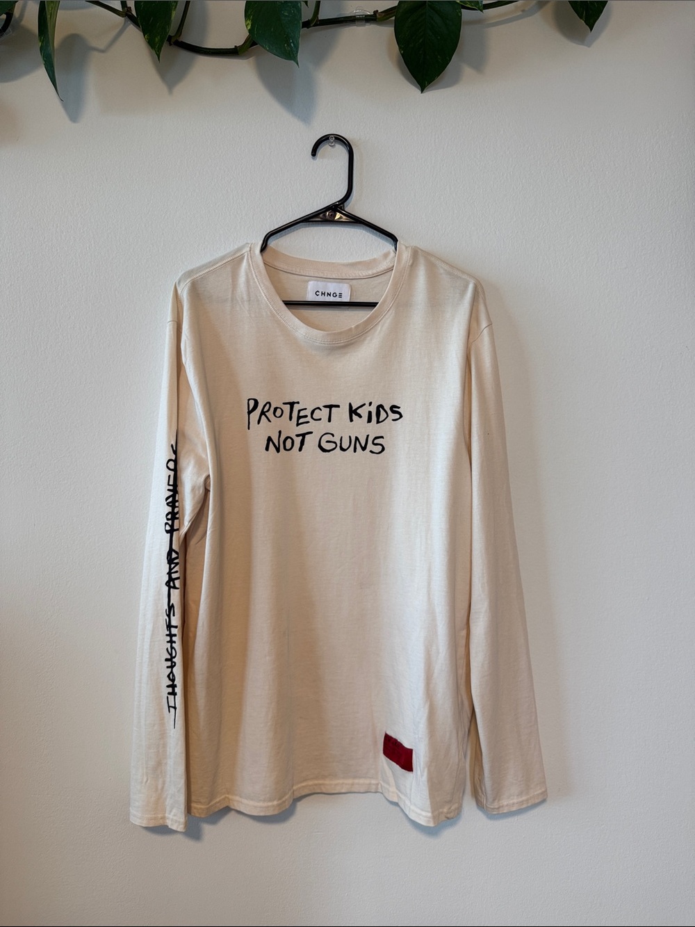 CHNGE Cream Long Sleeve Tee with Black Slogan and Red Patch, 100% cotton